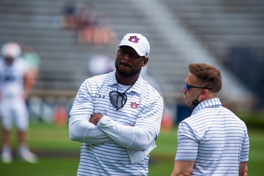 <p>Coach Carnell "Cadillac" Williams speaks to an assistant &nbsp;prior to the 2021 Auburn Football A-Day scrimmage, on Saturday, April 17, 2021, in Auburn, Ala.&nbsp;</p>