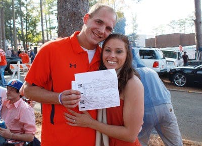James and Kelly show off their marriage license. (Emily Adams/PHOTO EDITOR)
