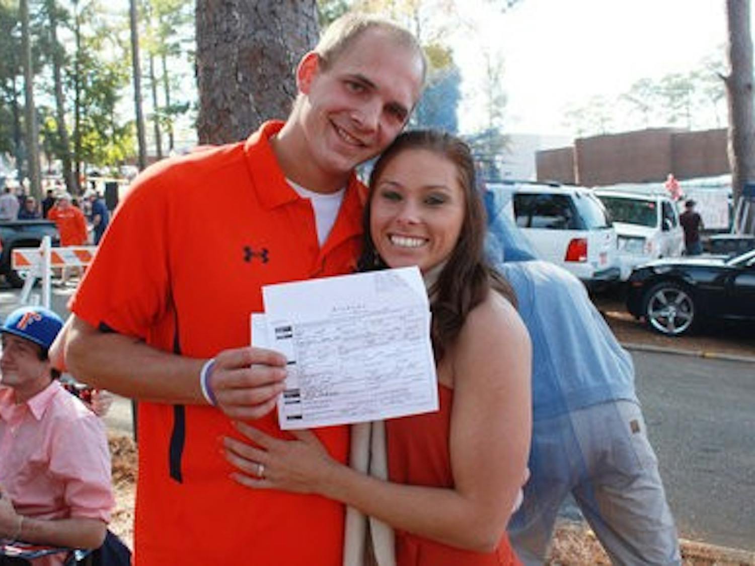 James and Kelly show off their marriage license. (Emily Adams/PHOTO EDITOR)