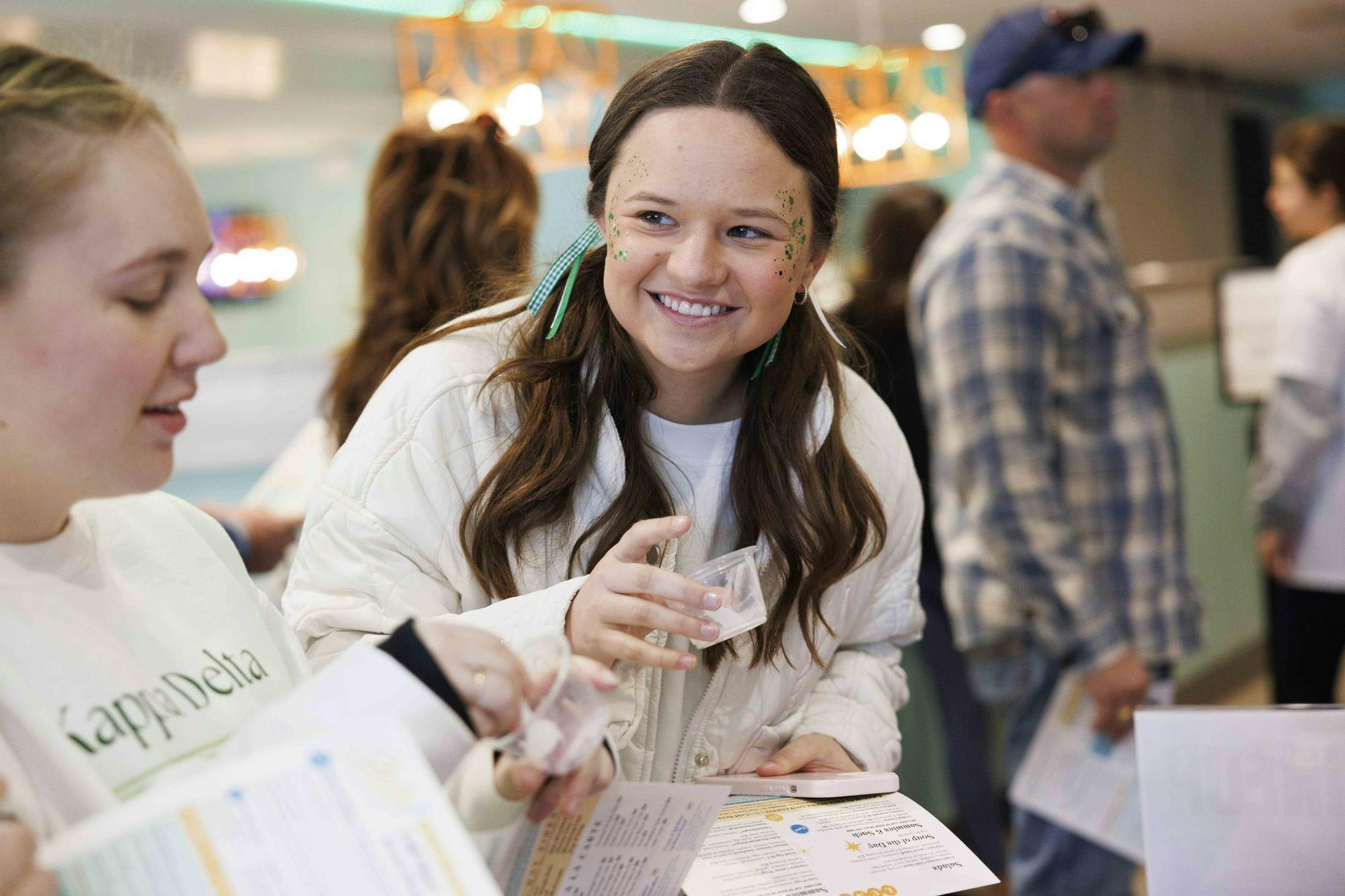 Tori Schultz smiles and expresses emotion after trying a sample of ice cream from, locally owned, Spoonlight Ice Cream during National Ice Cream for Breakfast day in Staks Pancake Kitchen, Feb. 7, 2026 in Auburn, Ala.