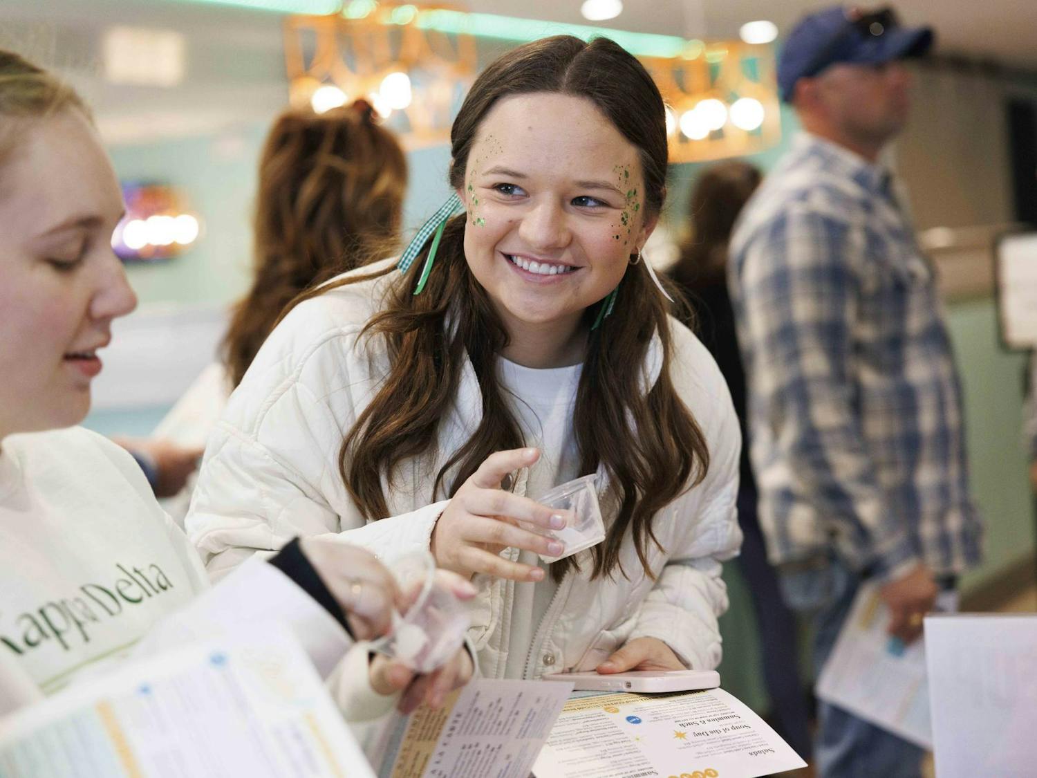 Tori Schultz smiles and expresses emotion after trying a sample of ice cream from, locally owned, Spoonlight Ice Cream during National Ice Cream for Breakfast day in Staks Pancake Kitchen, Feb. 7, 2026 in Auburn, Ala.