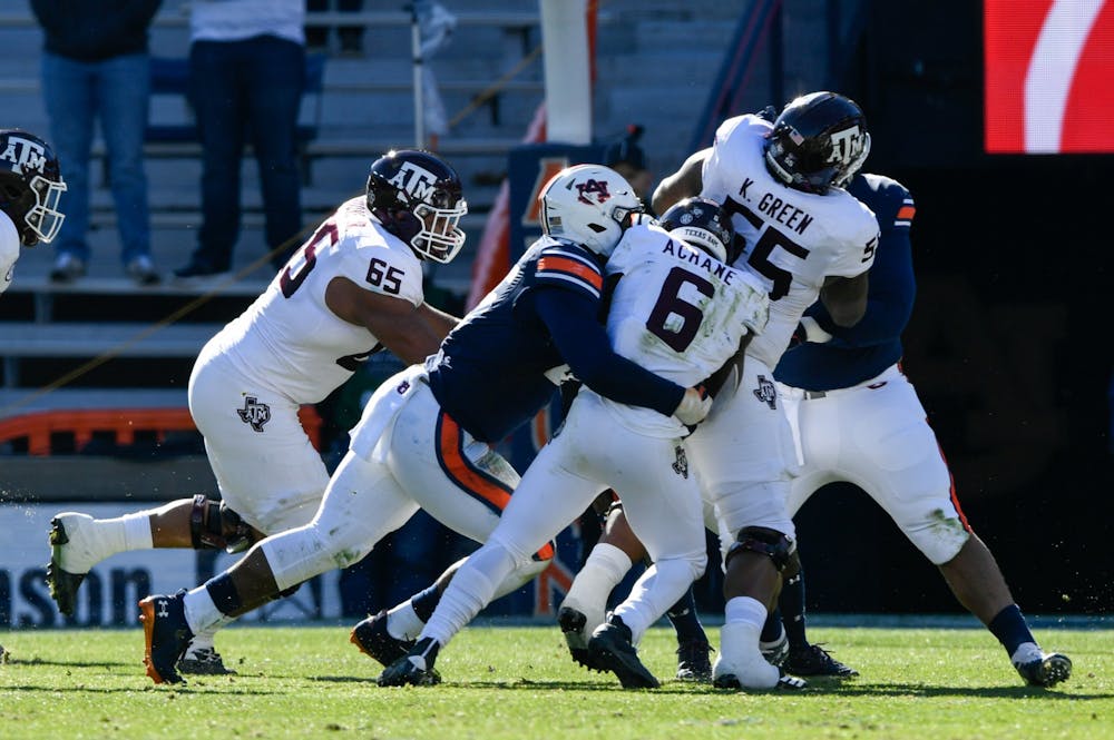 <p>Dec. 5, 2020; Auburn AL, USA; Colby Wooden (25) makes the tackle in the backfield during the game between Auburn and Texas A&amp;M at Jordan Hare Stadium. Mandatory Credit: Todd Van Emst/AU Athletics</p>