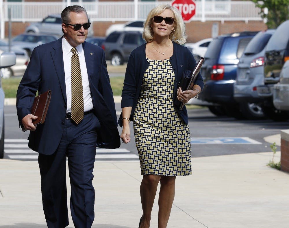 Mike Hubbard and Susan Hubbard walk to the Lee County Justice Center.