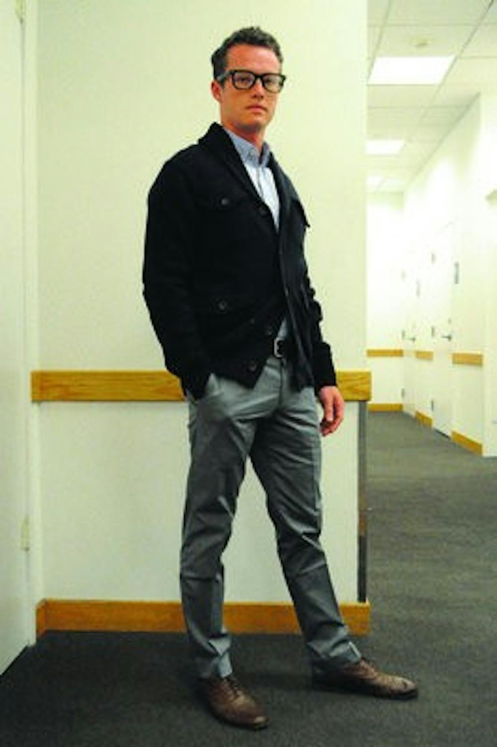 Gray Gill models a slim, one-pocket shirt with straight leg classic khakis and a four-pocket shawl cardigan for a daytime business casual look from The Gap. (Christen Harned / ASSISTANT PHOTO EDITOR)