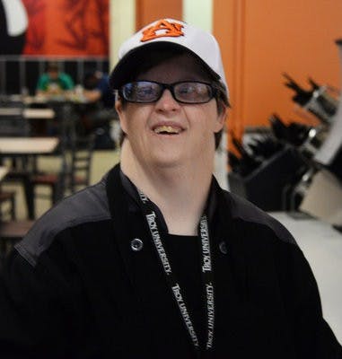 Ann Finlen shows her school spirit while she works in Foy Dining Hall.