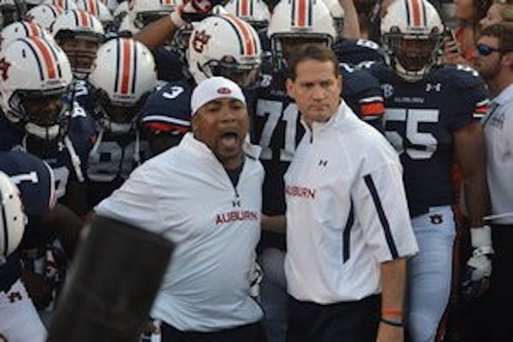 Coaches Gene Chizik and Trooper Taylor with the team. (Danielle Lowe / ASSISTANT PHOTO EDITOR)