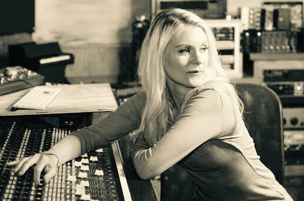 <p>Voice actress and Auburn alumna Kate Higgins sits in a recording studio.&nbsp;</p>
