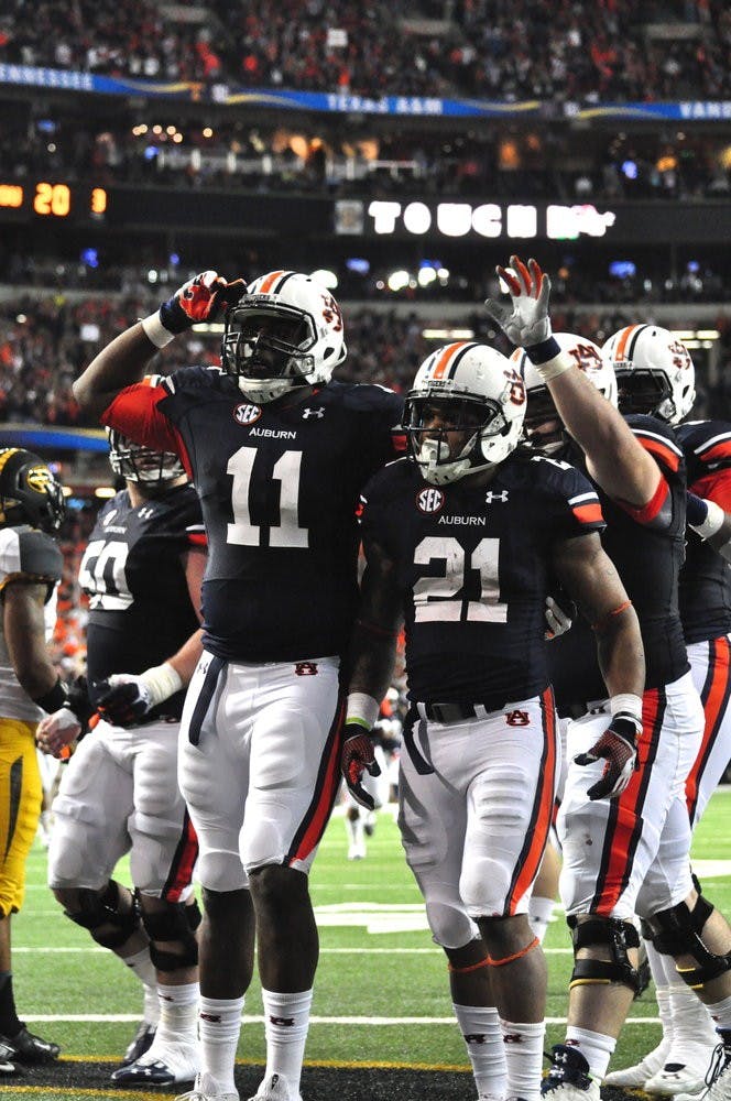 Brandon Fulse and Tre Mason celebrate an Auburn touchdown. Anna Grafton / PHOTO EDITOR
