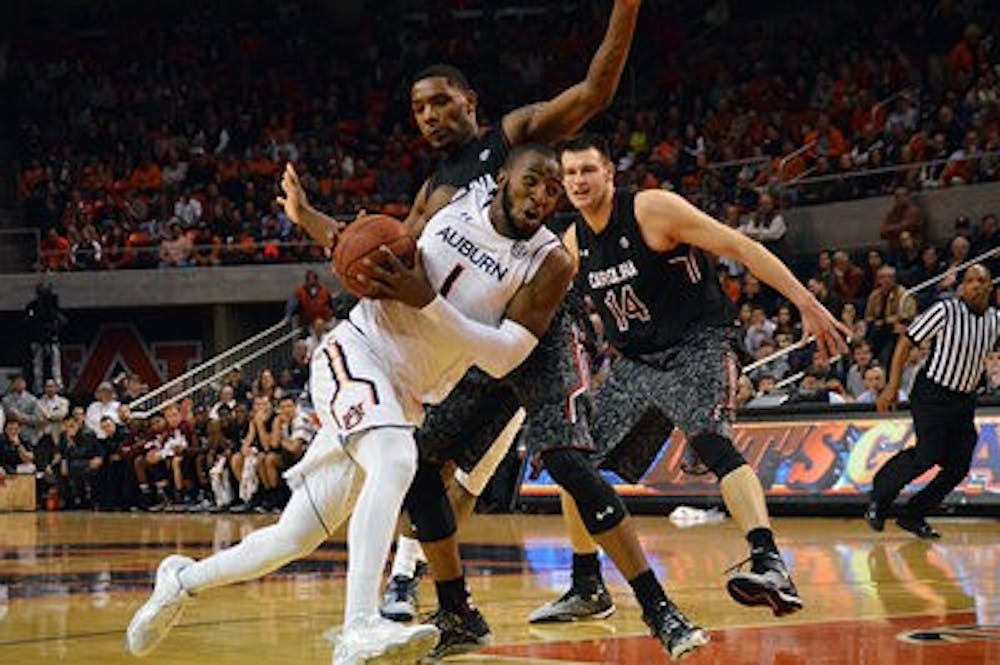 <p>KT Harrell drives into the paint against South Carolina (Emily Enfinger / Photo Editor)</p>