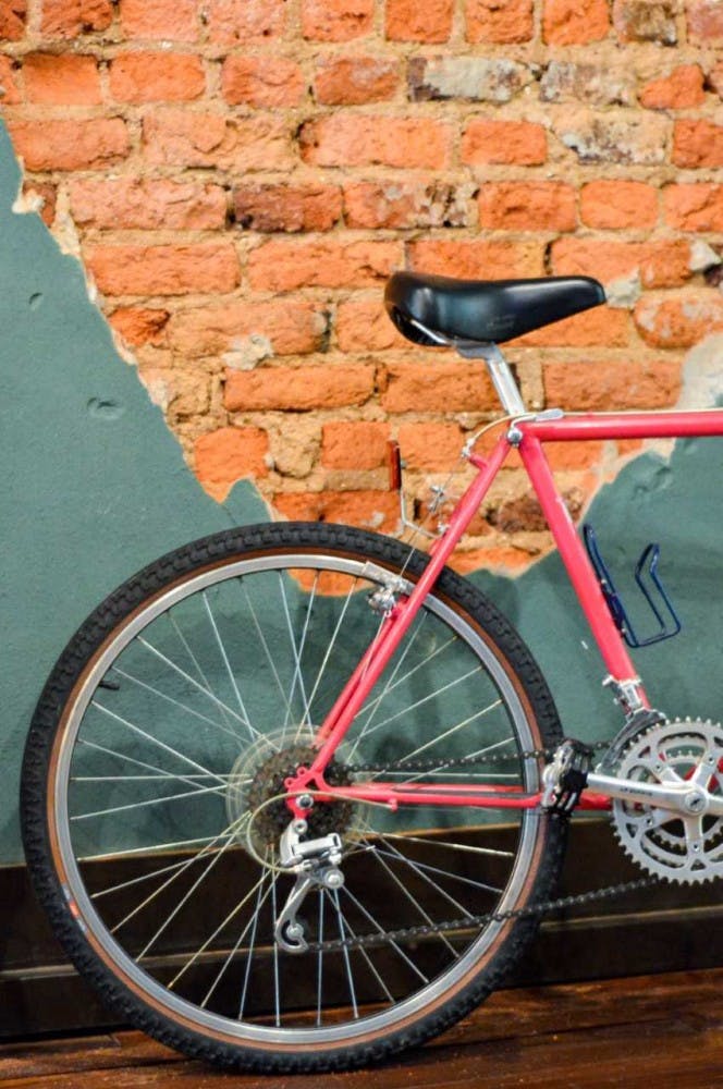 A bike sits parked by an aged brick wall in James Bros Bike shop in downtown Opelika, Ala.&nbsp;