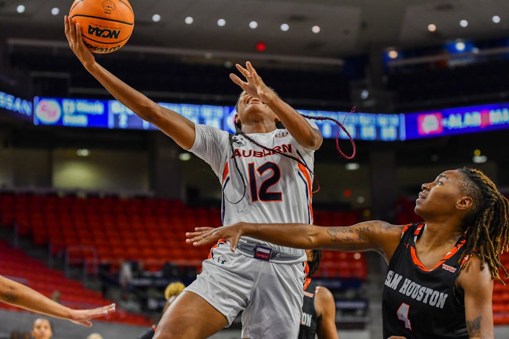 Ma'Shaun Bostic (#12) completes a layup in a match against Sam Houston at Neville Arena on November 8th, 2022
