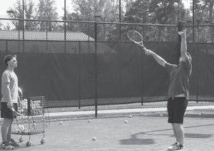 Colt Ponder, senior in anthropology, and Carl Fox, junior in fitness, performance and conditioning practice serves at the Yarbrough Tennis Center. (Andrew Yawn / COMMUNITY EDITOR)