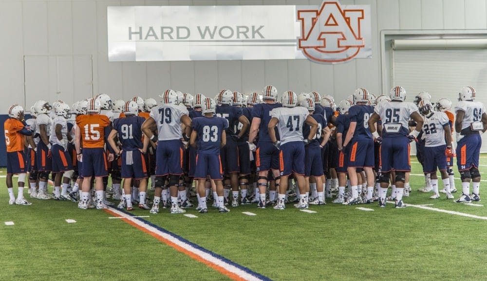 The Auburn football team takes in a few words from head coach Gus Malzahn during practice at the Auburn Athletic Facility, Tuesday, March 29, 2016.  