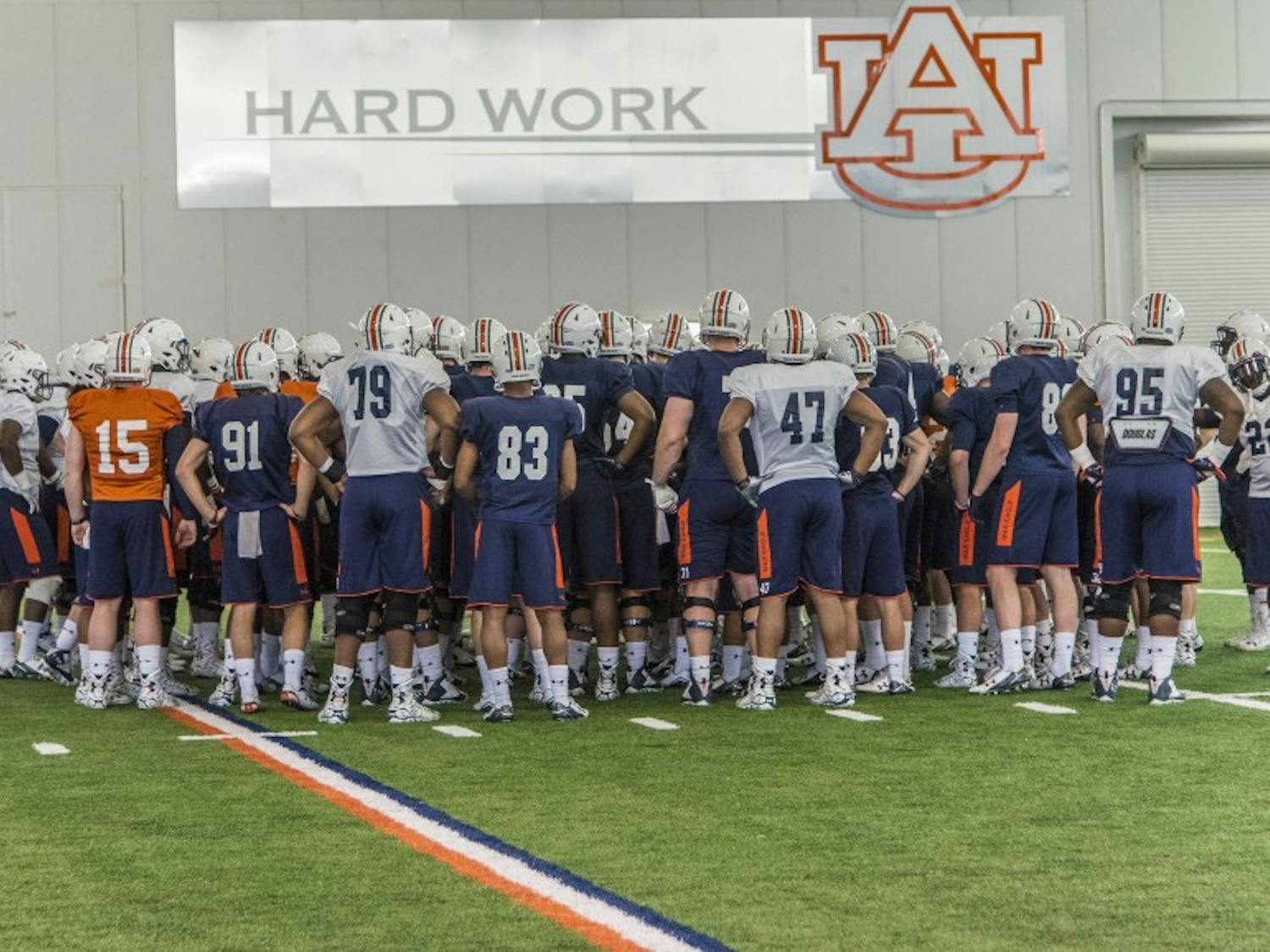 The Auburn football team takes in a few words from head coach Gus Malzahn during practice at the Auburn Athletic Facility, Tuesday, March 29, 2016.  