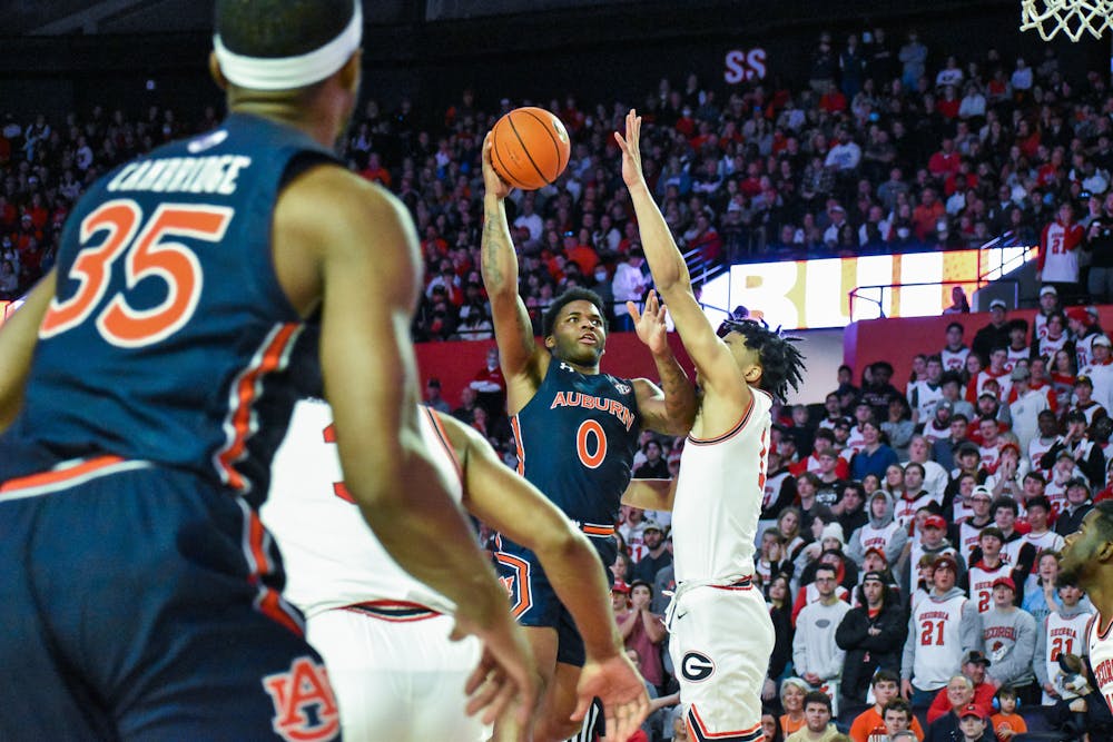 February 5, 2022; Athens, Georgia; K.D. Johnson (0) rises up to shoot a floater over a defender during a match between Auburn and Georgia in Stegeman Coliseum.