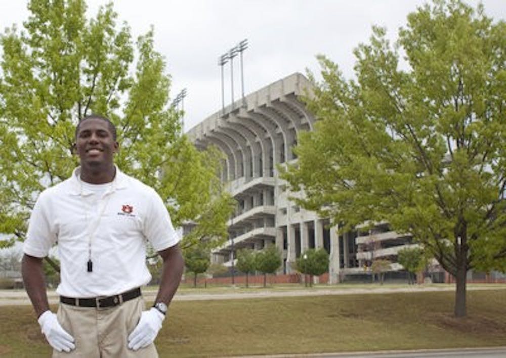 Daniel Johnson stands in front of Jordan-Hare stadium where he will lead the band next football season. (Emily Adams / Photo Editor)