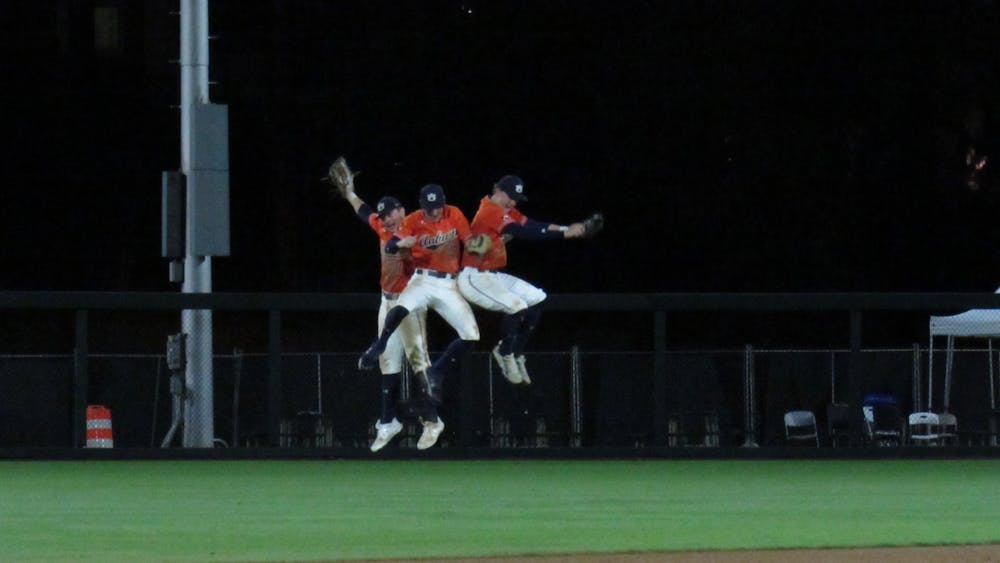 <p>Outfielders Mike Bello (31), Kason Howell (5), and Bryson Ware (8) celebrate a win over Ole Miss on March 18, 2022 at Plainsman Park in Auburn, Ala.</p>