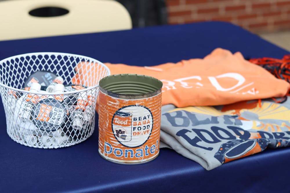 <p>Beat Bama Food Drive often hosts tables on the concourse to urge students to help those in need however they can, as pictured here.</p>