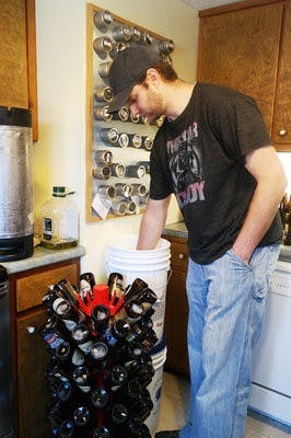 Kerry McGinnis sanitizes the bottles to be used for Red Clay brewery