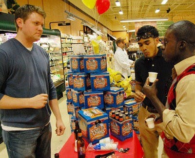 Kent Owusu (right) and Mohammad Hossain (center) sample Samuel Adams Octoberfest. (Charlie Timberlake / ASSISTANT PHOTO EDITOR)
