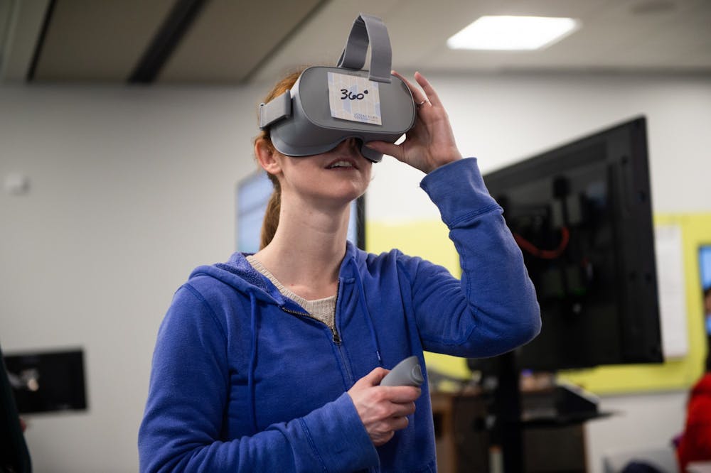 <p>Student interacts with virtual reality headset at the Biggio Center.</p>