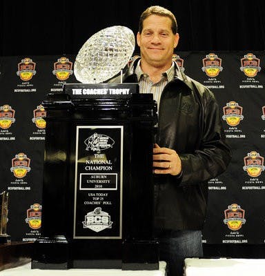 Auburn coach Gene Chizik with the Coaches' Trophy. (Todd Van Emst / Auburn Media Relations)
