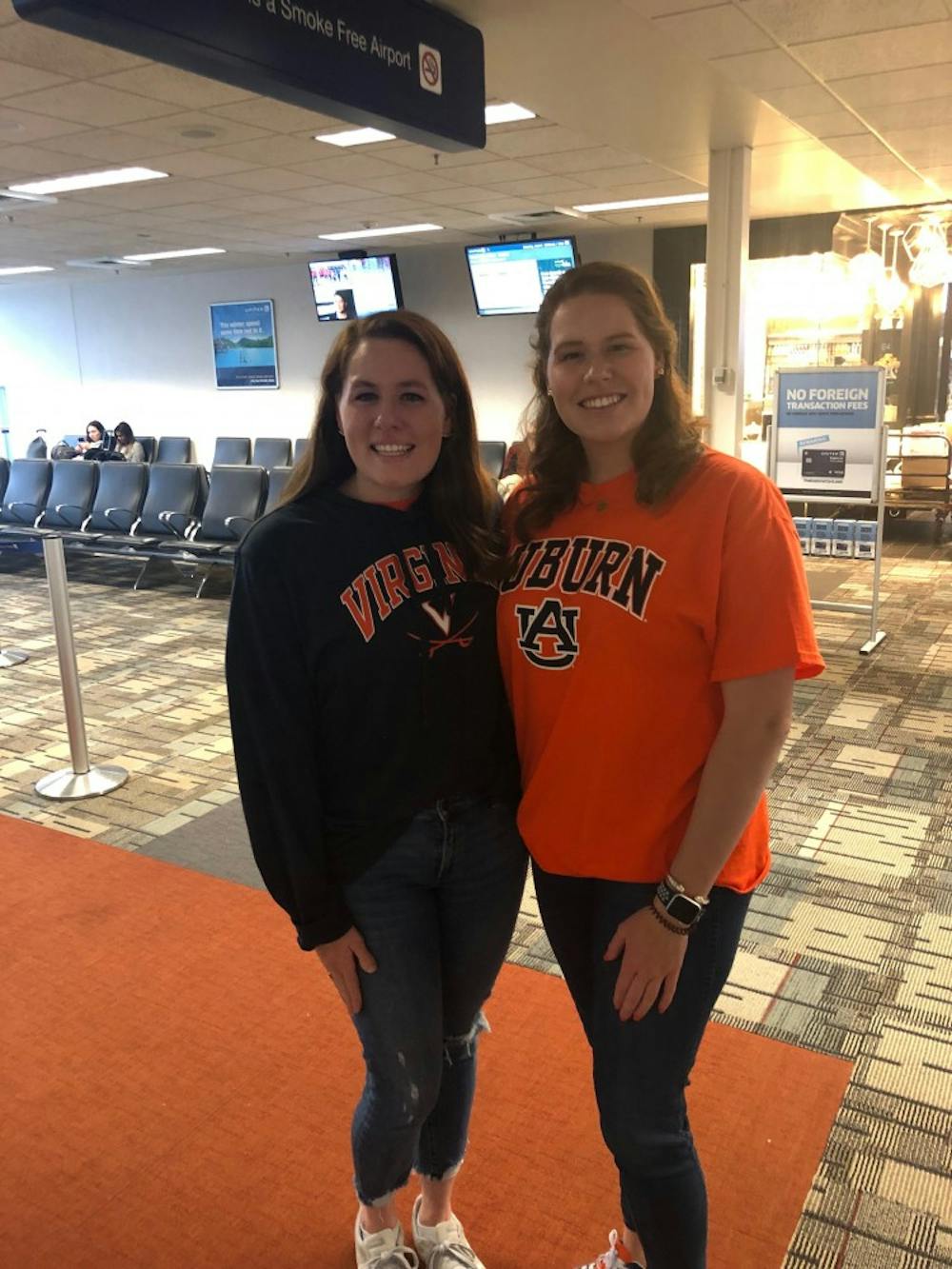 Kate and Courtney Anne Nappi dressed in their respective school attire as they arrive in Minneapolis to attend the Final Four matchup between Auburn and Virginia on Saturday, April 6, 2019. 