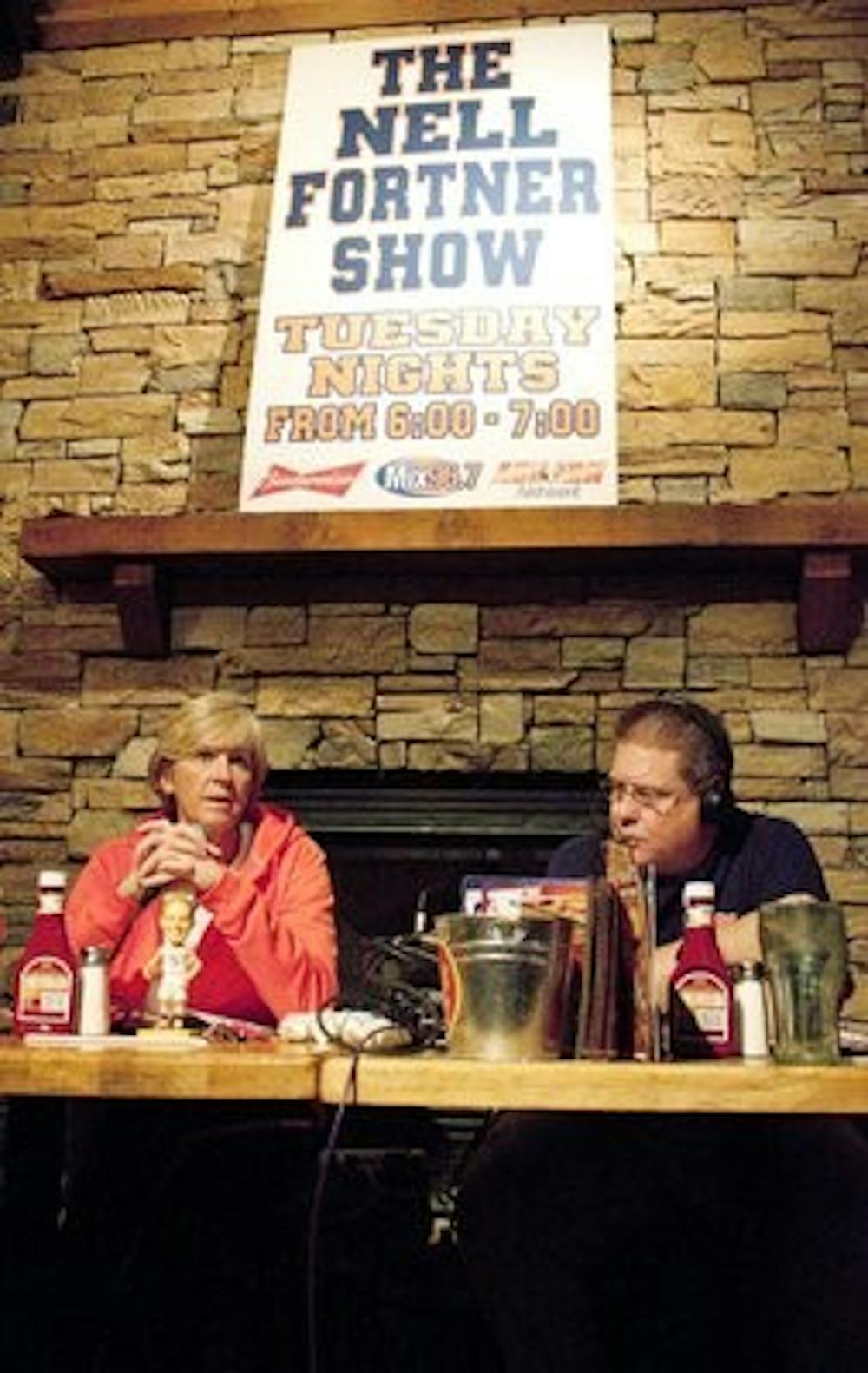 Women's basketball coach Nell Fortner talks on her radio show at Logan's with Mix 96.7's Andy Burcham. (Emily Adams / Photo Editor)