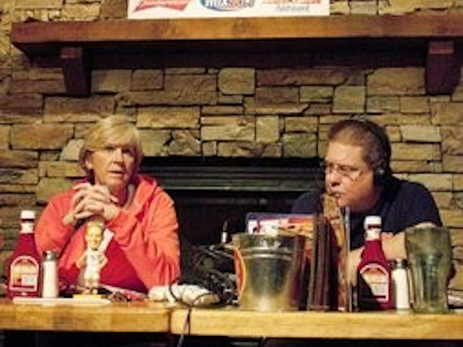Women's basketball coach Nell Fortner talks on her radio show at Logan's with Mix 96.7's Andy Burcham. (Emily Adams / Photo Editor)