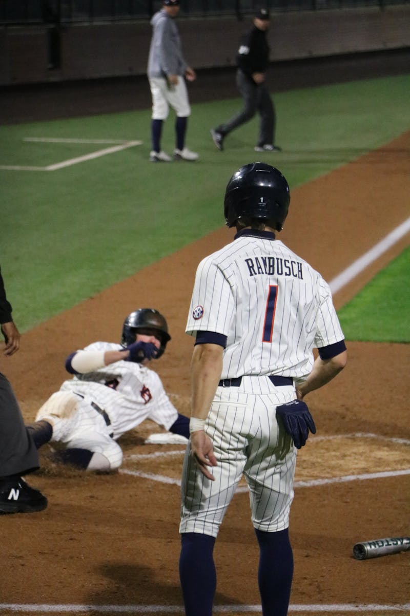 Auburn Baseball Blake Rambusch (1) watches as teammate Brody Moore (4) slides into home plate vs. Alabama State on Tuesday March 1, 2022