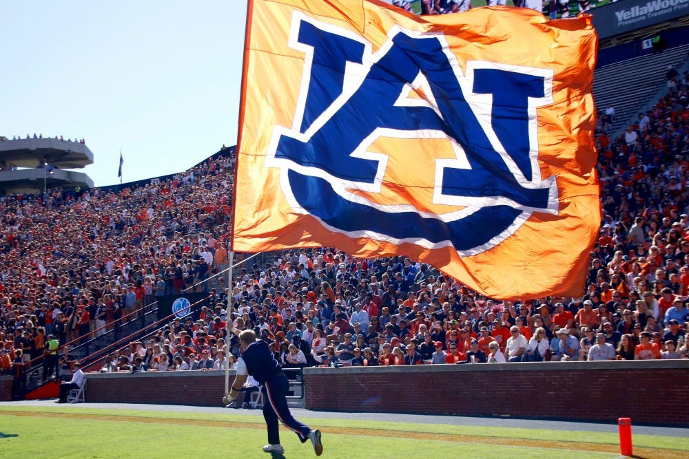 Auburn cheerleader Jackson Walraven&nbsp;runs with the flag during&nbsp;Auburn vs Vanderbilt football game in Jordan-Hare stadium Nov. 5, 2016.