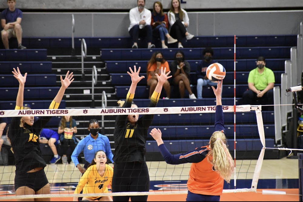 <p>Oct. 16, 2021; Auburn, AL, USA; Liz Reich (8) stretches out before launching the ball over the net in a match between Auburn and Missouri in the Auburn Arena.</p>