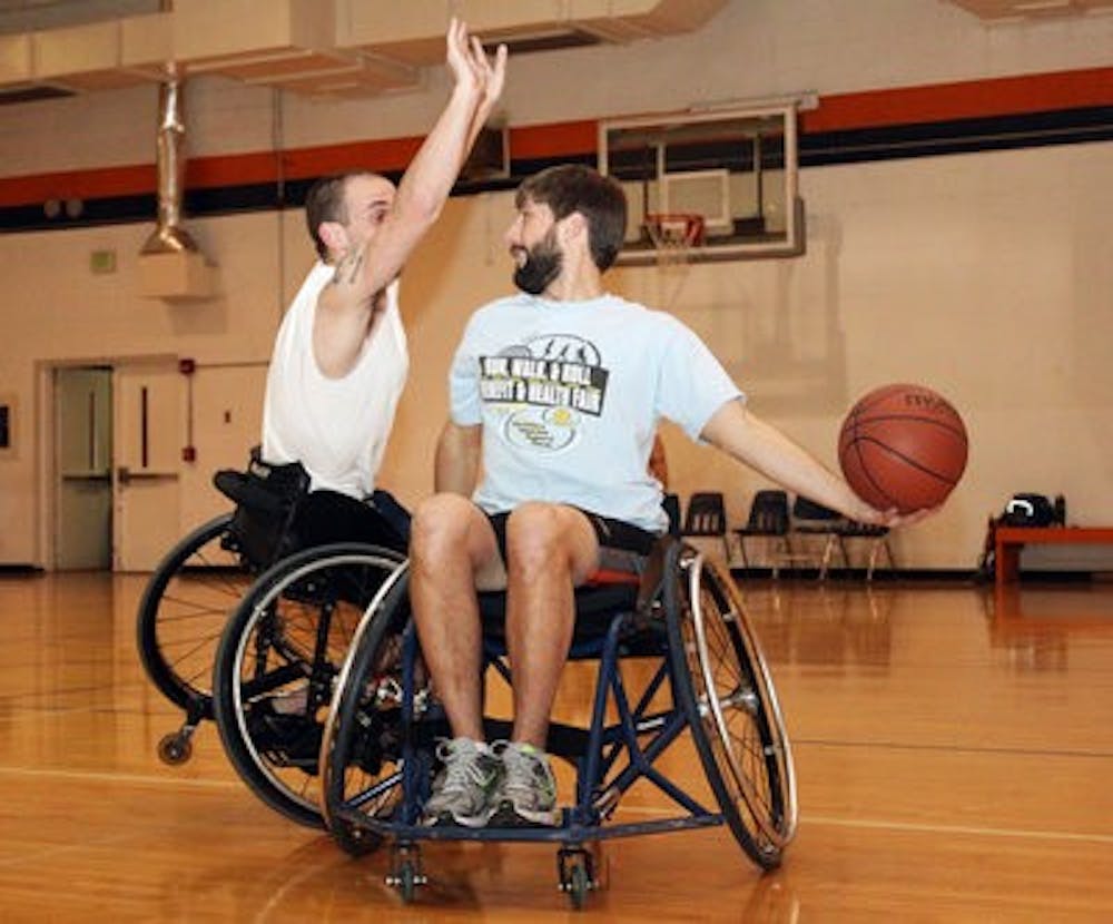 Jared Rehm and Nathan Waters practice defense at a wheelchair basketball practice. (Emily Adams / Photo Editor)