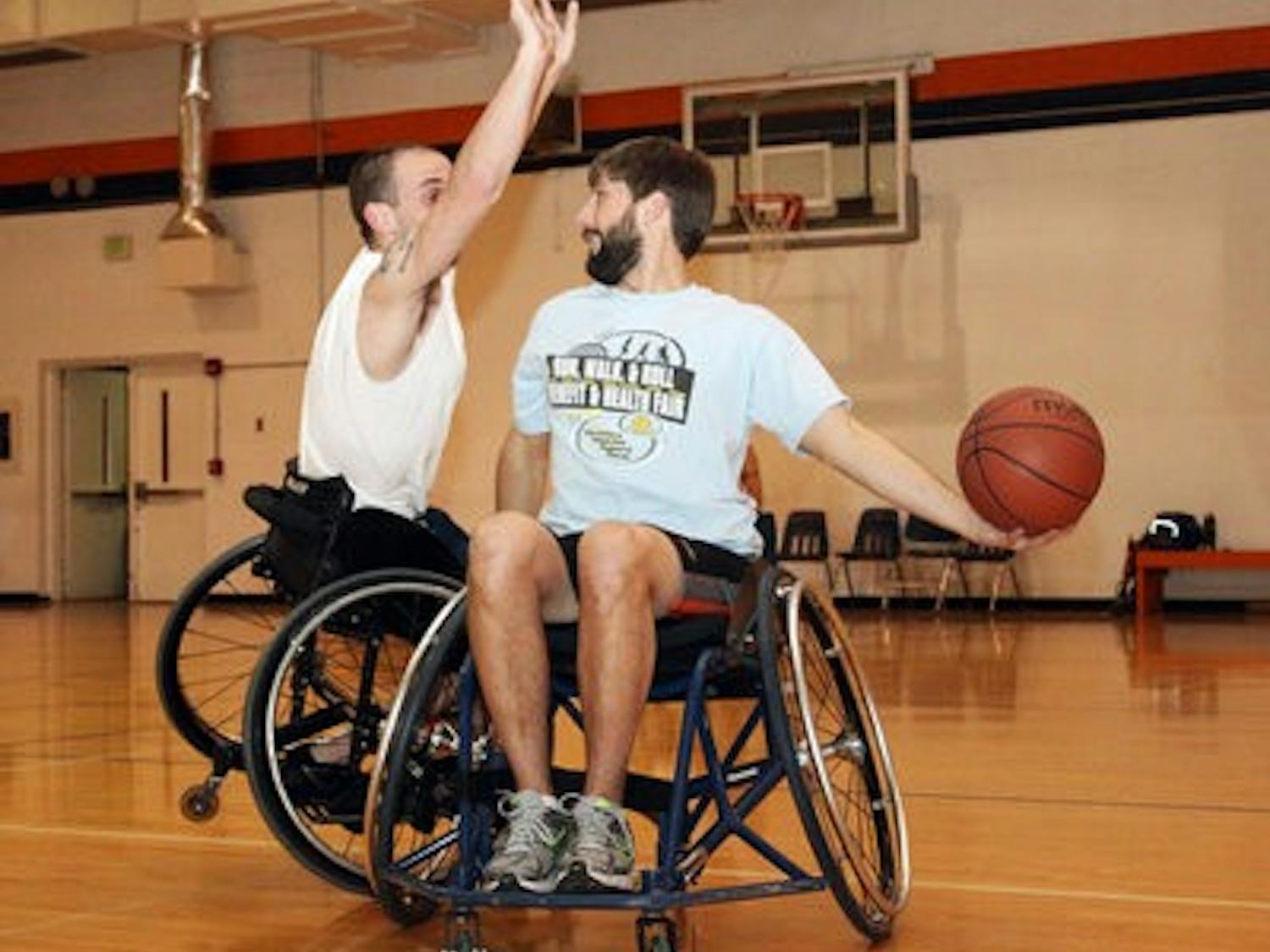 Jared Rehm and Nathan Waters practice defense at a wheelchair basketball practice. (Emily Adams / Photo Editor)