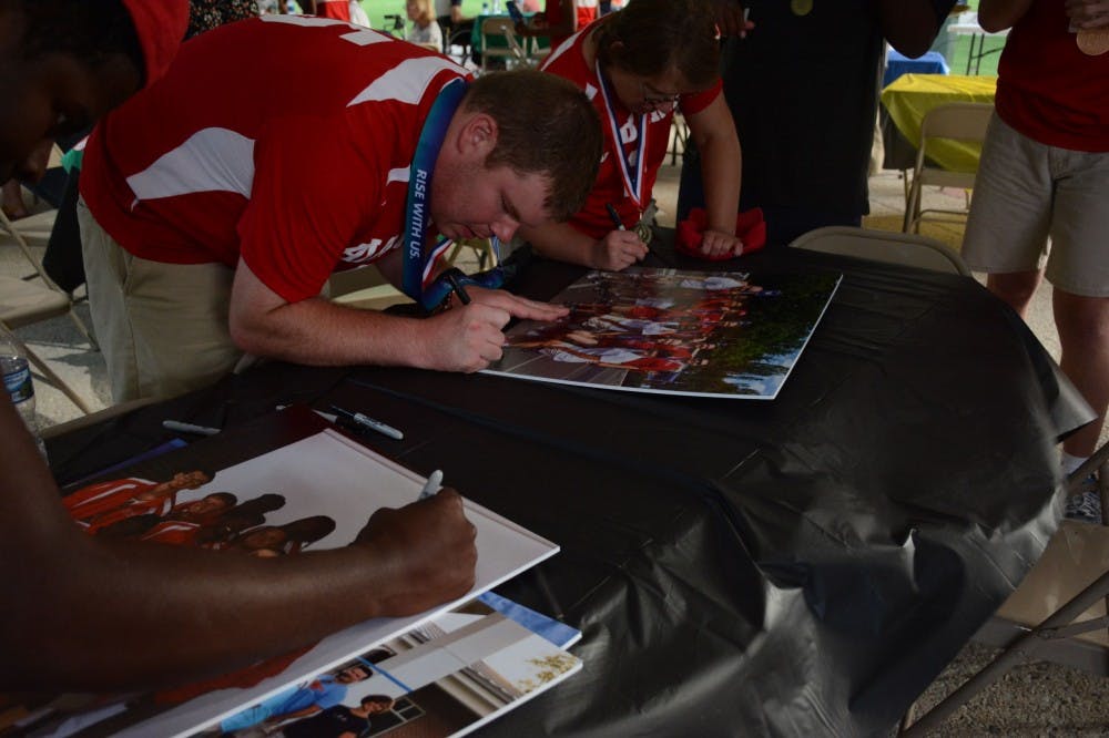 <p>Lee County Special Olympics athletes sign their pictures from the USA Games on Thursday, July 26, 2018&nbsp;at Kiesel Park in Auburn, Ala.&nbsp;</p>