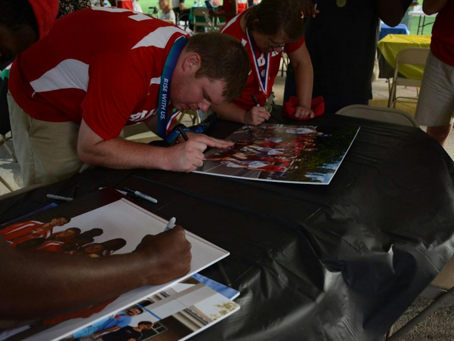 Lee County Special Olympics athletes sign their pictures from the USA Games on Thursday, July 26, 2018&nbsp;at Kiesel Park in Auburn, Ala.&nbsp;