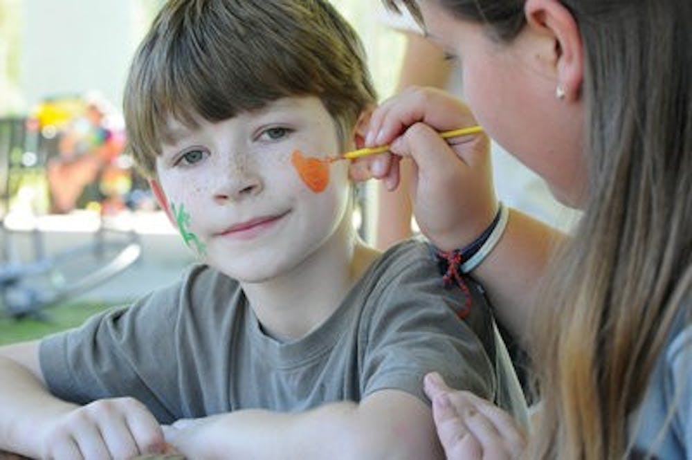 Hunter Sanders, 7, has a tiger painted on his face as part of the activities at the Auburn chapter of International Justice Mission's Freedom Fest at Town Creek Park Sunday. (Christen Harned / ASSISTANT PHOTO EDITOR)