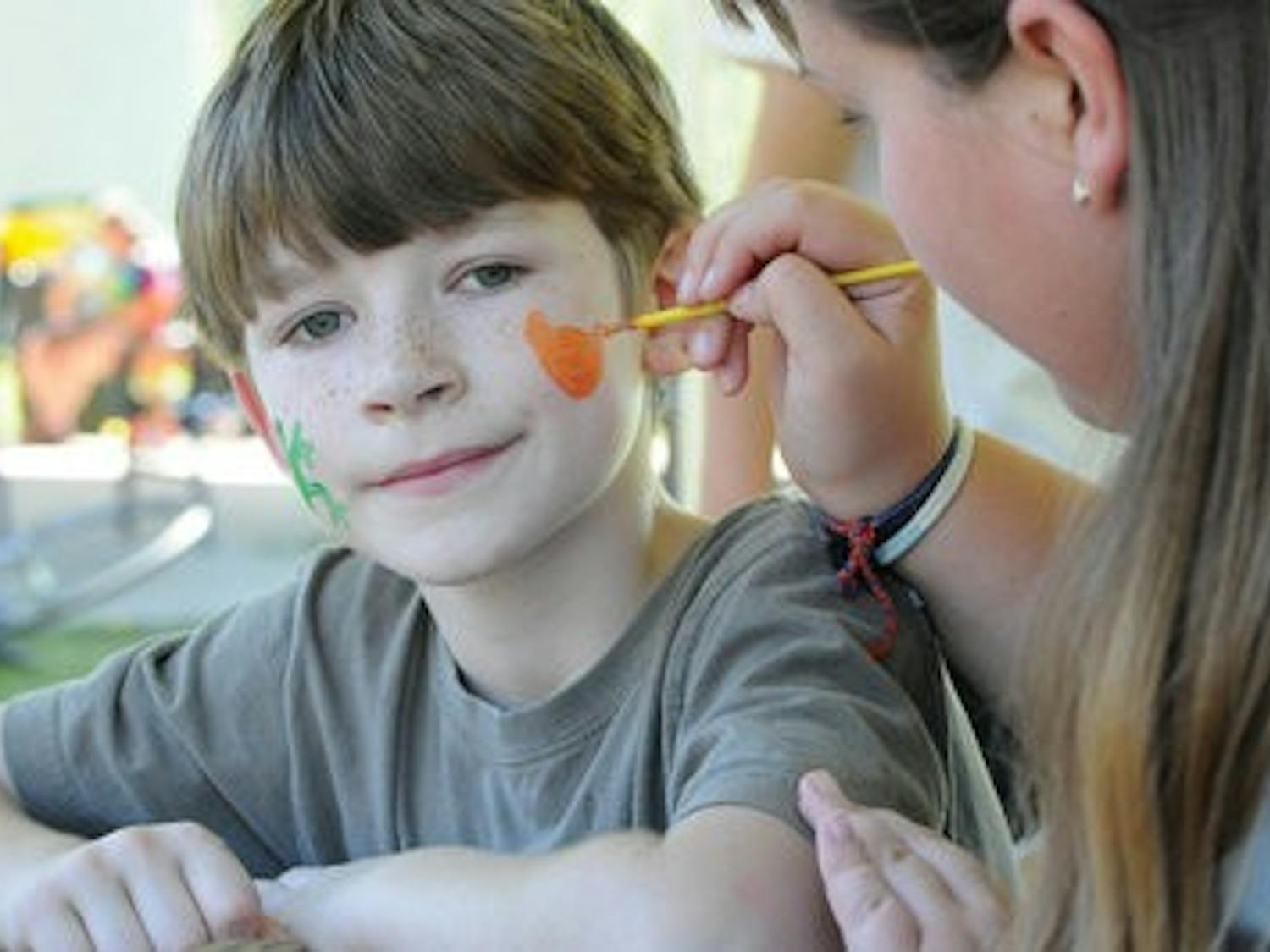 Hunter Sanders, 7, has a tiger painted on his face as part of the activities at the Auburn chapter of International Justice Mission's Freedom Fest at Town Creek Park Sunday. (Christen Harned / ASSISTANT PHOTO EDITOR)