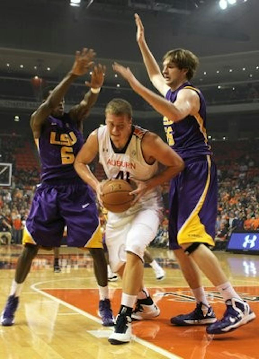 Senior Rob Chubb tries to get around 2 LSU defenders to get a basket.
(Katharine McCahey / PHOTOGRAPHER)