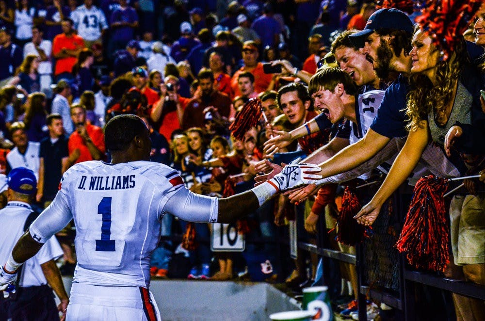 D'haquille "Duke" Williams celebrates with fans after defeating Kansas State.

Raye May / PHOTO EDITOR