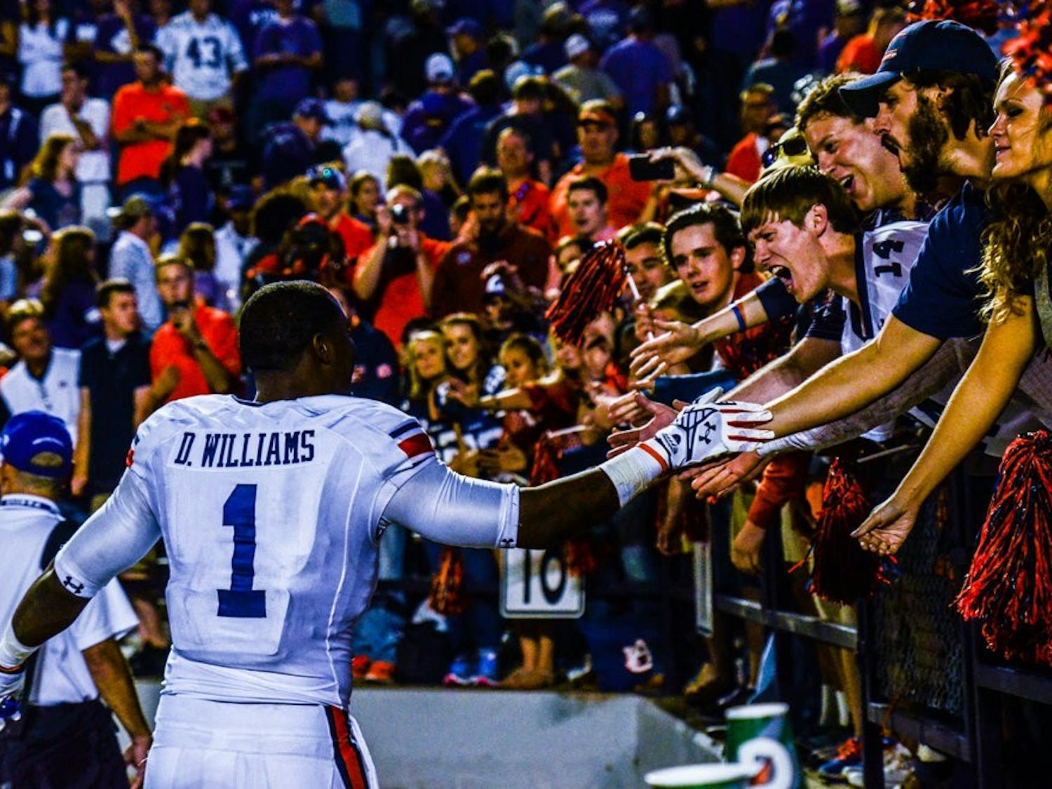 D'haquille "Duke" Williams celebrates with fans after defeating Kansas State.
Raye May / PHOTO EDITOR