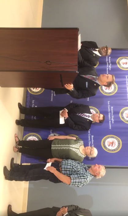 Lee County District Attorney Brandon Hughes speaks at a press conference.