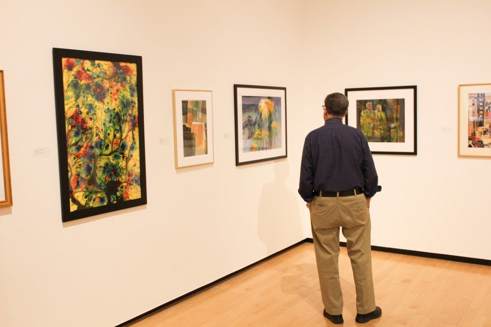 <p>A man admires the watercolor exhibit at the Jule Collins Smith Museum of Art. </p>