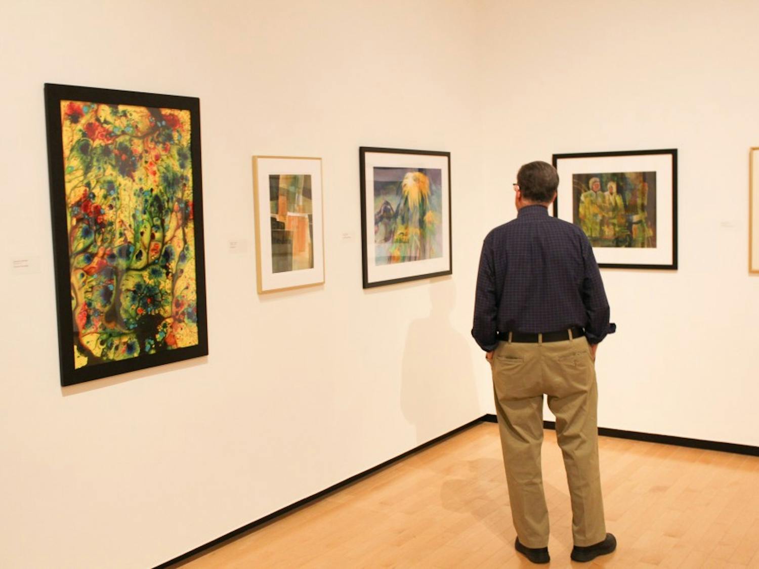 A man admires the watercolor exhibit at the Jule Collins Smith Museum of Art. 