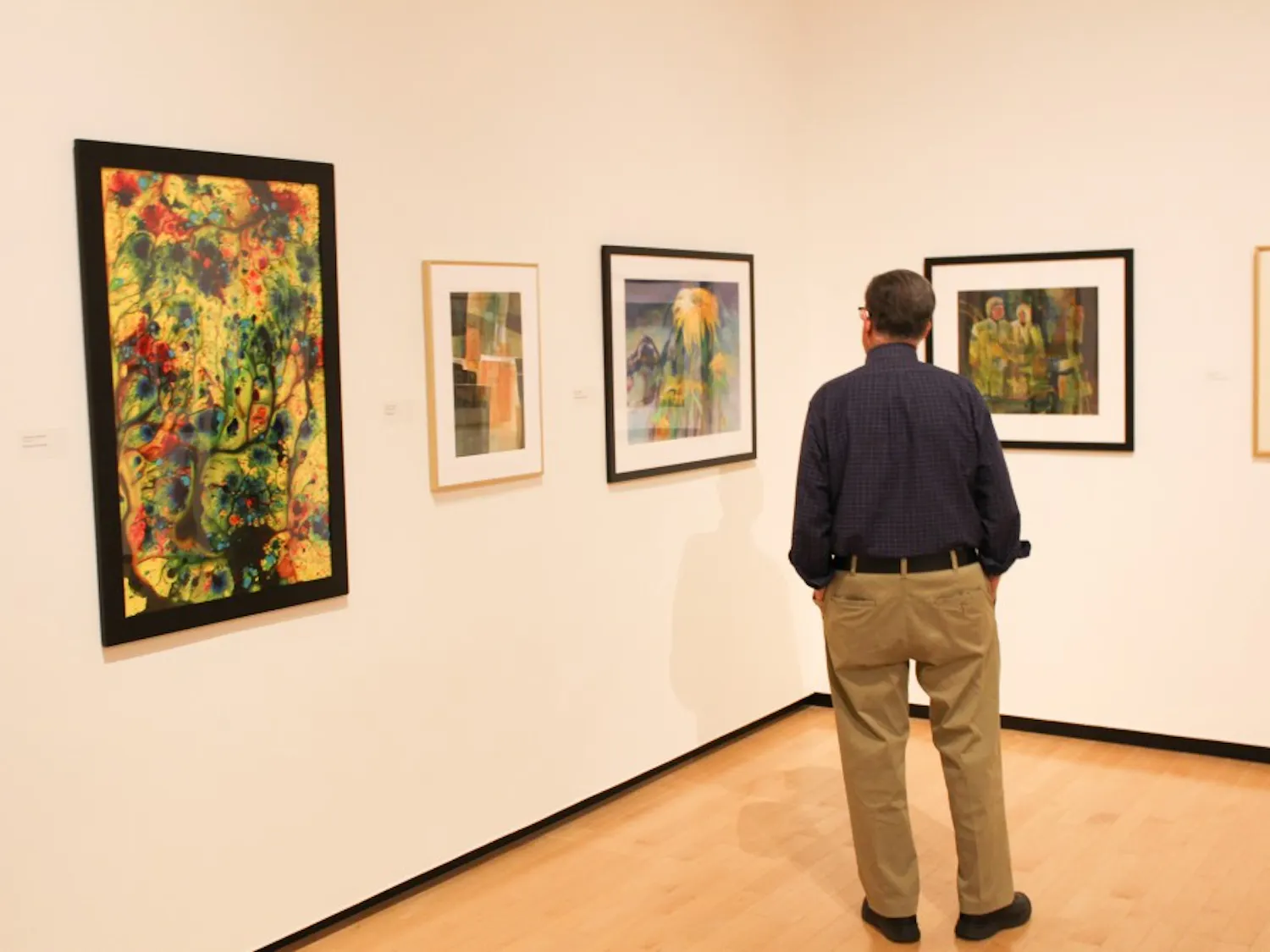 A man admires the watercolor exhibit at the Jule Collins Smith Museum of Art.
