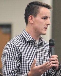 Zack St. Clair, freshman in political science, poses a question to the panel. (Rebecca Croomes / PHOTO EDITOR)