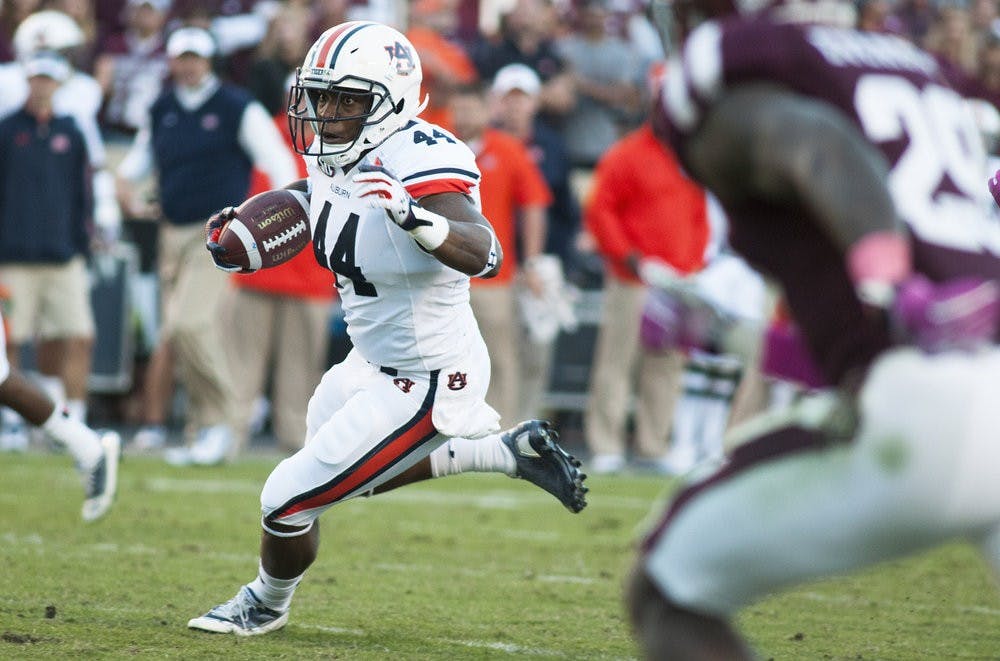 Auburn running back Cameron Artis-Payne (44) runs down the field against Texas A&M, Oct. 19, 2013. (Zach Bland / Photographer)