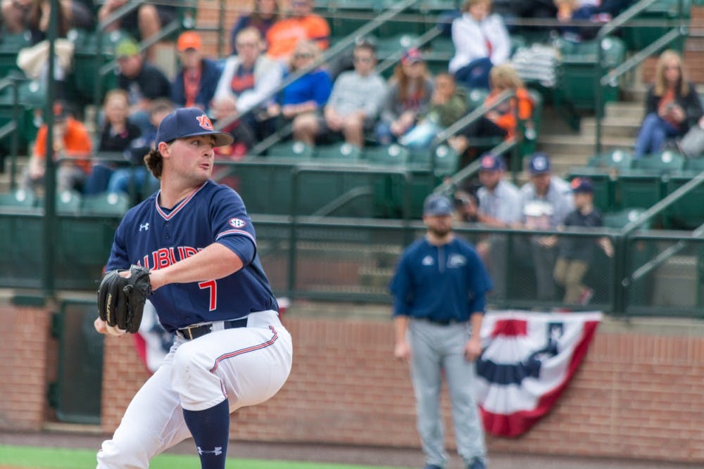 Tanner Burns (7) winds up to pitch the ball during Auburn vs. Longwood on Sunday, Feb. 18, 2018, in Auburn, Ala.
