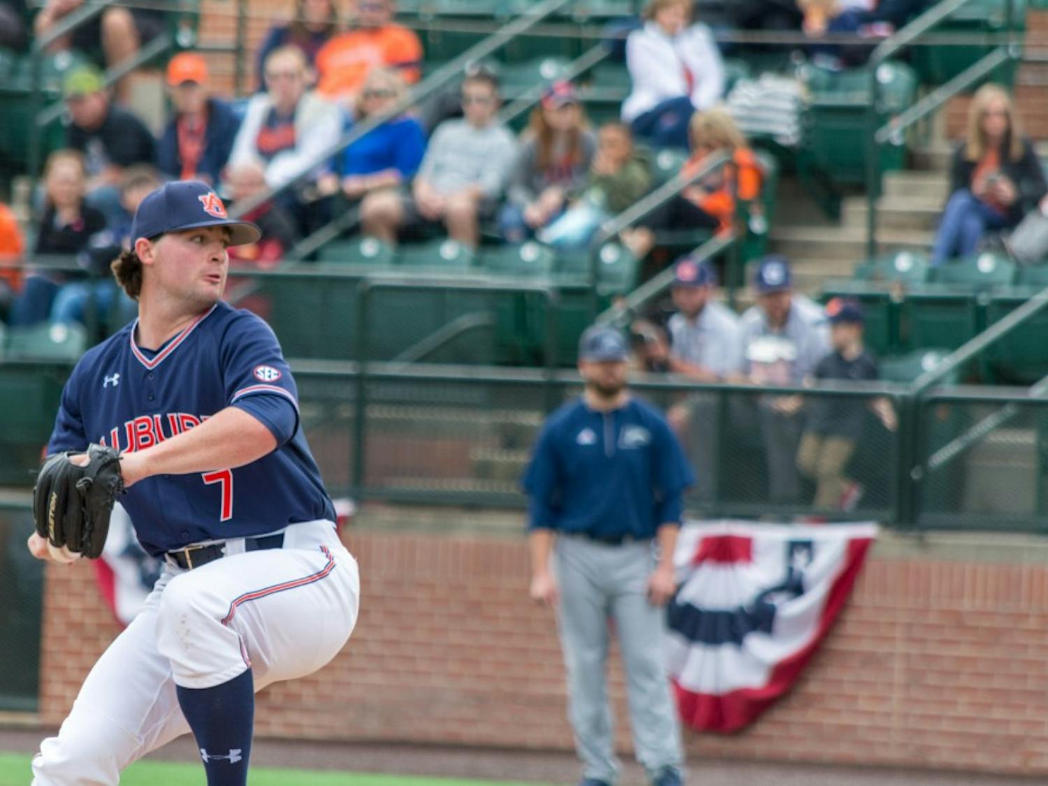Tanner Burns (7) winds up to pitch the ball during Auburn vs. Longwood on Sunday, Feb. 18, 2018, in Auburn, Ala.