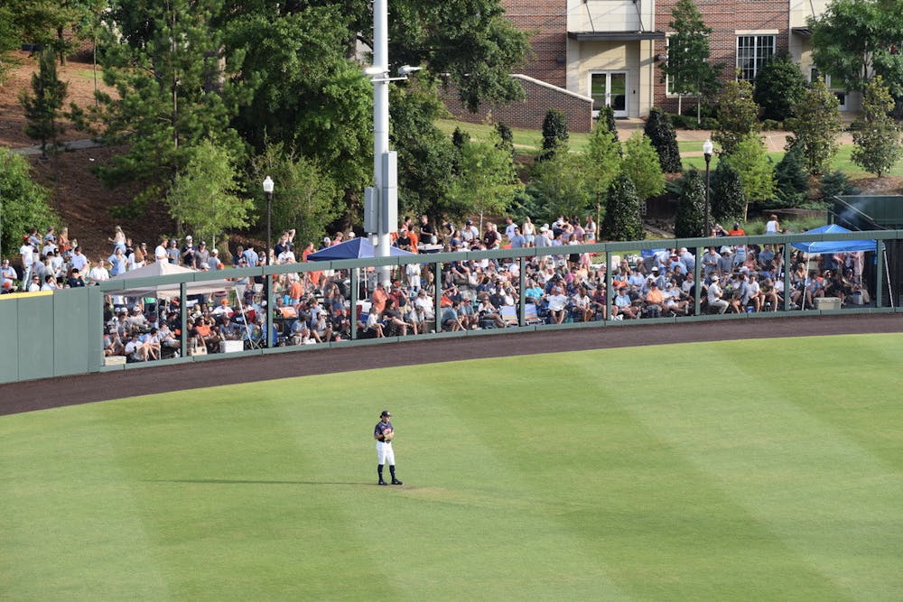 <p>Kason Howell covers center field in front of a mob of students and fans outside Plainsman Park.</p>
